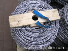 Galvanized barbed wire fence