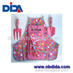 A3 steel garden tool and pink background and color polka dots gloves and Apron