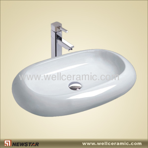 Oval ceramic sink with tap