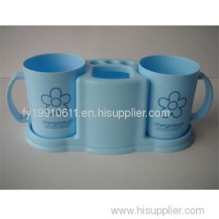 Plastic rack with cup and toothbrush and toothpaste holder