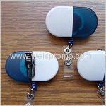 Capsule shaped retractable badge holder