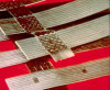 strip bounded geogrids with high tenacity polyester core