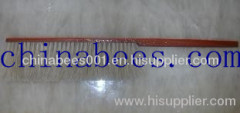 bee brush with wooden handle and red paint