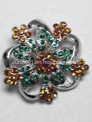 Metal brooch with flowers and crystals