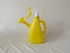 yellow plastic watering can