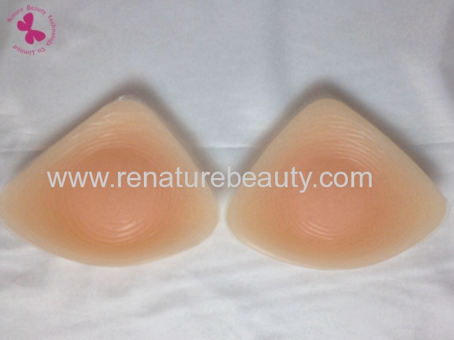Triangle and oval and spiral shaped silicone breast enhancer for bigger breasts after surgery