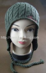 Cable needle earflap hat with part of fleece lining