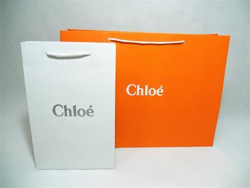 orange square and oblong handle bags