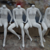 white sitting female mannequins