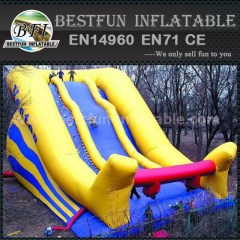 Inflatable climbing wall with slide