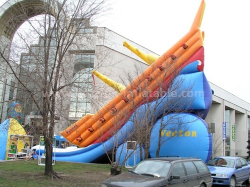 Inflatable slide in boat shape