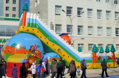 Inflatable trampoline with slide