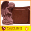 Angel kneeling red tombstone