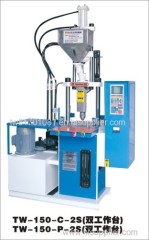 Vertical injection molding machine with double side operation