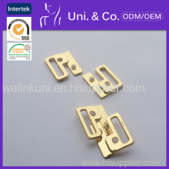 Alloyed front closure buckle for swimwear accessories