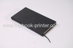 Embossed cover black calf-bound leather diary with black ribbons