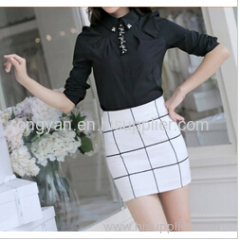 Women's black dress shirt on skirt