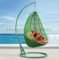 Colorful rattan wicker hammock with cushions for outdoor