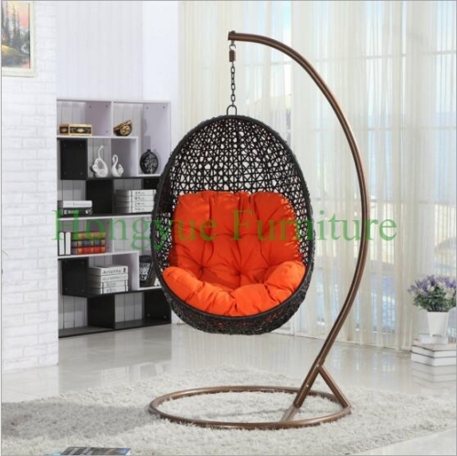 Brown rattan hammock with orange cushions supplier
