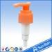 Orange plastic lotion pump for shampoo bottle