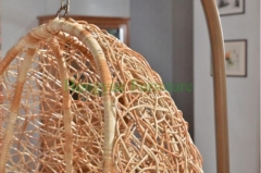 Yellow color rattan hammock with grey cushions