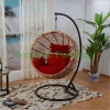 Yellow wicker rattan hammock with red cushions