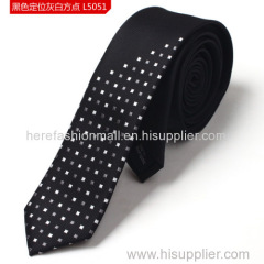 Background black with grey and white blocks polyester woven neck tie