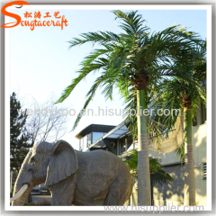 Large outdoor artificial Roystonea regia palm trees