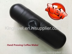 HAND PRESSING COFFEE CUP