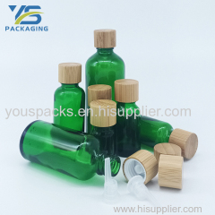 Transparent green empty glass bottle with bamboo screw cap