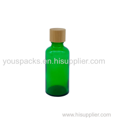 Transparent green empty glass bottle with bamboo screw cap
