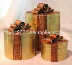 a set of 3 golden oval gift boxes