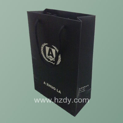 Black paepr bag with white logo