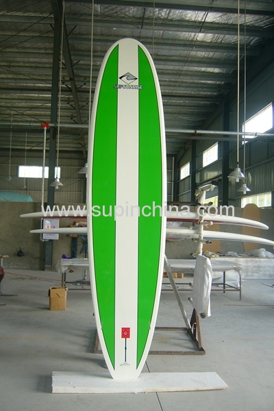green sup paddle board surfing