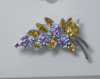 Metal brooch with flowers and crystals