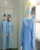 Surgical gown with knitted cuff