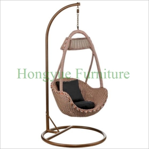 Outdoor patio rattan hammock with black cushions