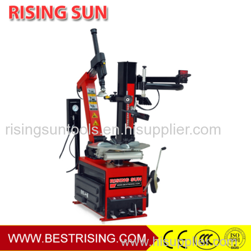 Tilt back tyre fitting machine with helper arm