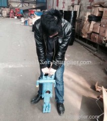 Pneumatic rock drilling machine with air leg