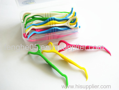 Green and white Y-shape dental floss pick