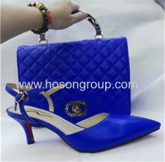 Women high heel sandals and matched handbag blue