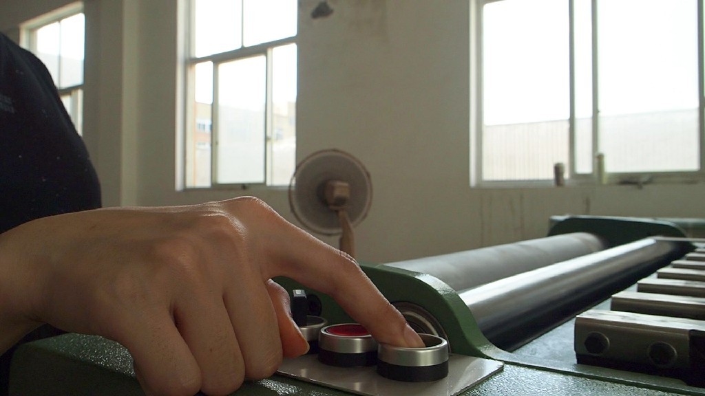 Take-up roller control on narrow fabric needle loom